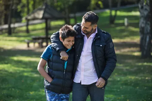 Man and son walking in park